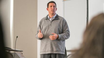 Bo speaking in front of UH students about the power of brand belief.