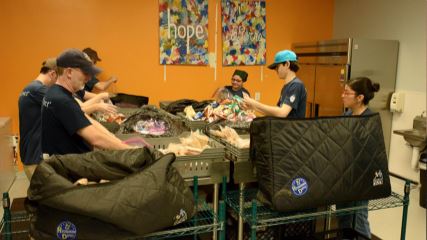 The BrandExtract team making sandwiches at Kids' Meals Inc. for impoverished children.