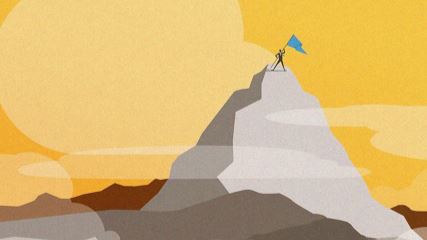 Man holding a flag on top of a mountain