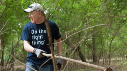 Scott lifting dead tree branches at Special CHEERS.