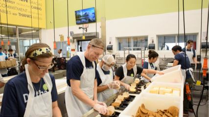 A picture of Julia packing food at the Houston Food Bank.
