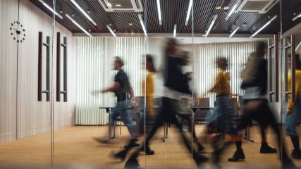 Group of blurry people walking in a building