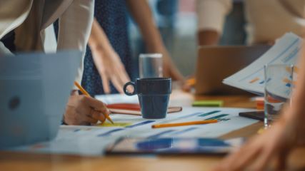 People writing on printed out charts