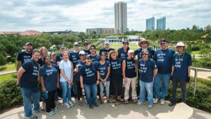 A group shot of the BrandExtract team after cleaning McGovern Centennial Gardens.