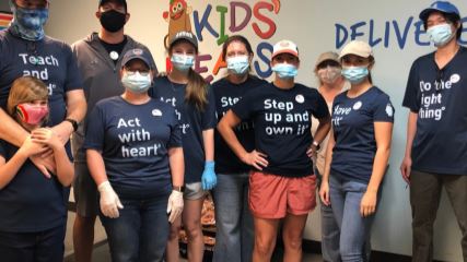 Yana, Michael, and Alexandria standing in front of the Battleship Texas.