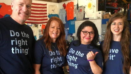 Four BE team members posing in their "Do the Right Thing" shirts at the Houston Community ToolBank.