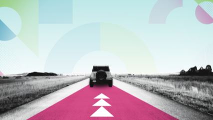 Graphic of a car driving down a road away from the camera, with a skyline of BE-branded geometric graphics.