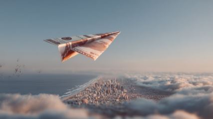 A paper airplane made out of a dollar bill soaring over a city