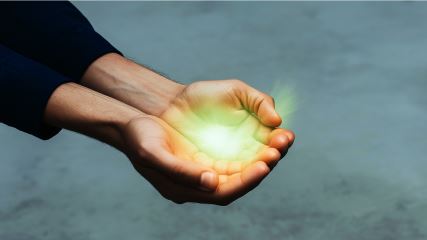 A pair of hands holding a green BrandExtract-branded sphere, passing the brand value to a new pair of hands.