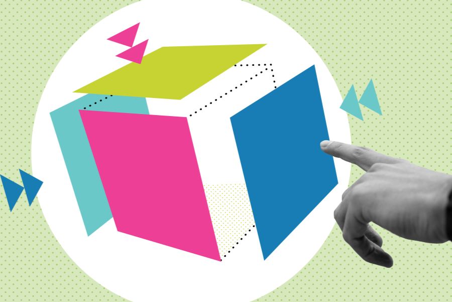 Black and white photograph of a hand pointing toward a cube made up of green, pink and blue BE-branded squares.