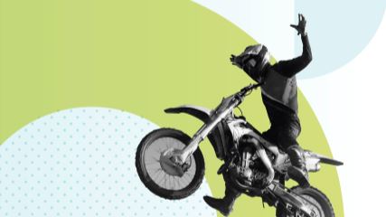 Photograph of a dirt biker with his arms outstretched to the sides, flying over a branded background with geometric light green and blue shapes