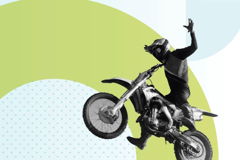 Photograph of a dirt biker with his arms outstretched to the sides, flying over a branded background with geometric light green and blue shapes