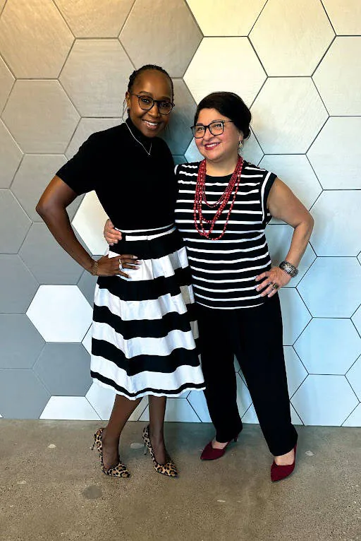 Cynthia and Charity posing in front of the BrandExtract wall