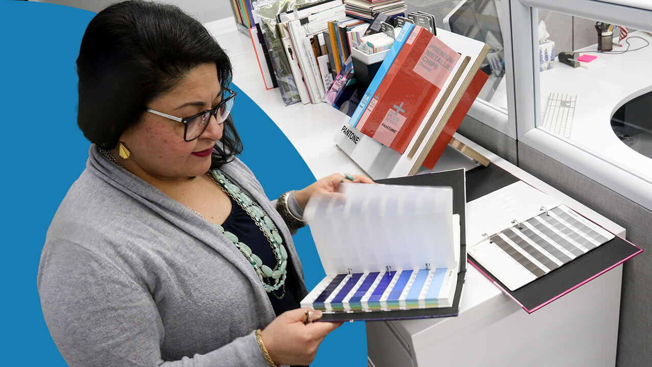 Cynthia flipping through color books looking at swatches.